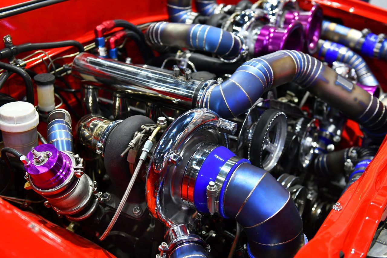 A turbocharged engine in a red engine bay